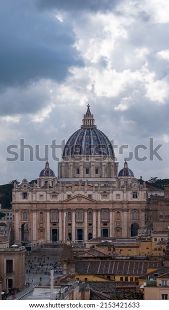 Vatican City, Vatican, March 2022. The beautiful\
Cathedral of Saint Peter pictured from Saint Angelo\'s Castle on a\
cloudy day.