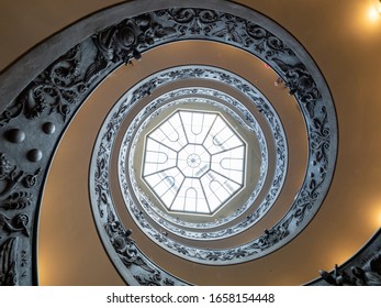 Vatican City State - October 29, 2019 : View looking up at the octagonal skylight above the Bramante Staircase in Vatican Museums (Musei Vaticani). It was designed by Giuseppe Momo in 1932.