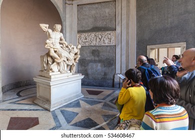 VATICAN, ITALY - NOVEMBER 2, 2016: tourists near Laocoon and His Sons (Laocoon Group) ancient sculpture in Gallery of Statues, open loggia of Pio-Clementino Museum in Vatican museums in Vatican city