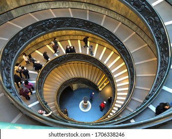 Vatican, Rome / Italy - Jan 3, 2020: People climbing down the Bramante Staircase of Vatican Museums. The double helix staircase is the famous travel destination of Vatican and Roma.