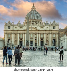 Vatican, Rome, Italy - October 9, 2019 - Tourists are photographed at sunset in front of St. Peter's Basilica in the Vatican