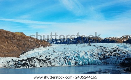 Vatnajokull glacier covered in frost in iceland, spectacular massive icebergs colored with white and blue. Frozen cold ice cap in icelandic winter landscape and arctic snowy mountains.