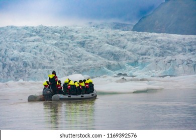 VATNAJOKULL, ICELAND - JULY 28, 201: Two families sailing on a Blue Ice Zodiac boat tour on the Fjallsarlon Glacial Lagoon on an arm of the huge Vatnajokull glacier in South Iceland