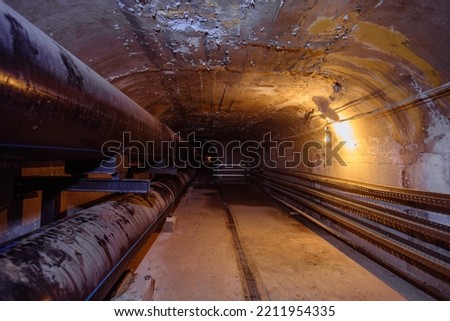 Vaulted concrete underground tunnel of sewer, heating duct or water supply system.