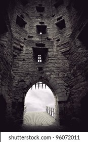 Vaulted medieval castle gate with portcullis