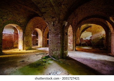 Vaulted red brick dungeon under old mansion.