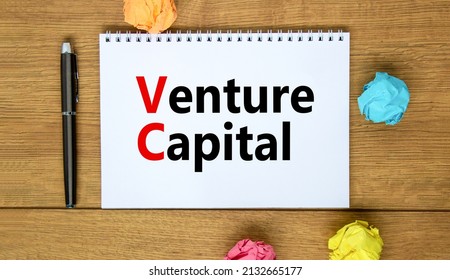 VC venture capital abbraviation symbol. Concept words VC venture capital on white note. Metallic pen. Beautiful wooden background. Copy space. Business and VC venture capital concept.