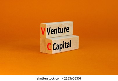 VC venture capital abbraviation symbol. Concept words VC venture capital on wooden blocks on orange table orange background, copy space. Business and VC venture capital concept.