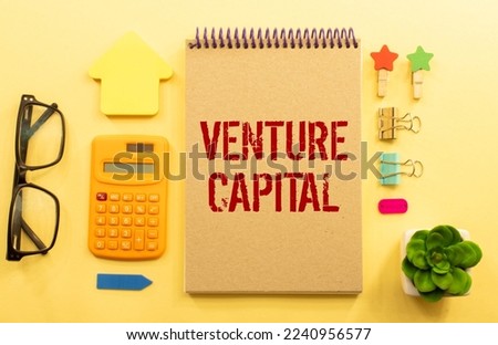 VC venture capital abbraviation symbol. Concept words VC venture capital on white note. Metallic pen. Dollar bills. Beautiful white background. Copy space. Business and VC venture capital concept.