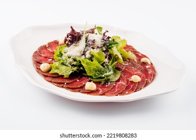 Veal Carpaccio With Parmesan Cheese On White Plate