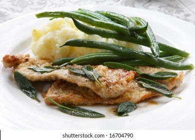 Veal Scaloppini, Panfried With Sage Leaves.  Served With Mashed Potatoes And Green Beans.