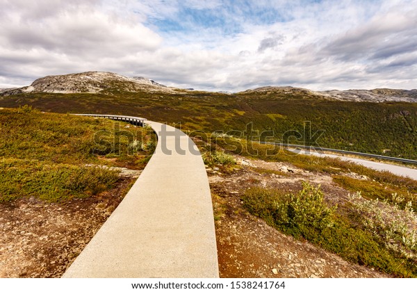 Vedahaugane resting\
point rest stop on road across mountains above Laerdal town,\
walkway with 25 metre long bench. National Tourist Route\
Aurlandsfjellet. Architecture\
Norway.