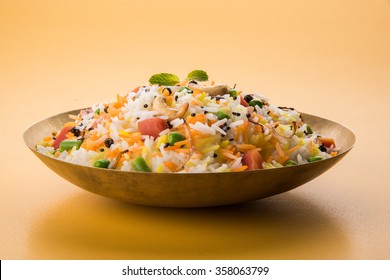 Veg Biryani Or Pulav Served In A Round Brass Bowl, Selective Focus
