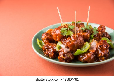 Veg Crispy is Batter Fried vegetables tossed with Chinese sauce tastes tangy. It's a popular Starters or appetizer in India. Served in a plate over colourful or wooden table top. Selective focus