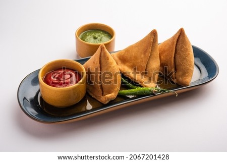 Veg Samosa - is a crispy and spicy Indian triangle shape snack which has crisp outer layer of maida  filling of mashed potato, peas and spices