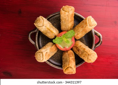 Veg Spring Rolls with mint leaf and green chutney or Tomato Ketchup. Selective focus