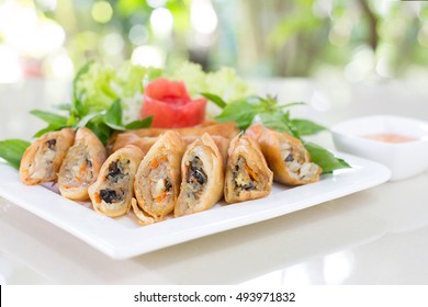  Veg. Spring Rolls and sweet sauce on white dish and wooden background, Thai food / Select focus Image, Adjustment blur and soft for background