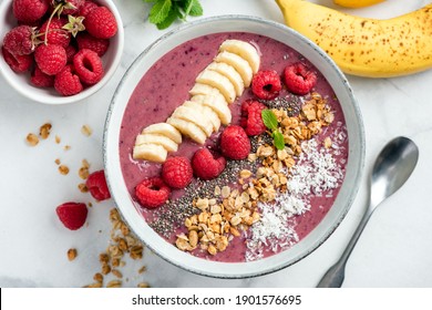 Vegan Acai Smoothie Bowl With Toppings Banana Raspberry Granola Coconut. Top view
