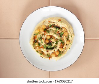 Vegan Bean Meal - Chickpea Hummus Garnished With Spices, Sesame, Parsley, Oil On Plate, From Above Overhead Top View, Closeup, Vegan Healthy Legume Food Concept