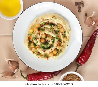 Vegan Bean Meal - Chickpea Hummus Garnished With Spices, Sesame, Parsley, Oil On Plate, From Above Overhead Top View, Closeup, Vegan Healthy Legume Food Concept