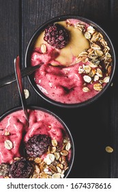 Vegan Berry Smoothie Bowl With Tahini And Muesli, Dark Background. Homemade Berry Ice Cream With Peanut Butter And Granola.