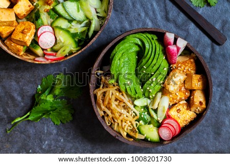 Vegan bowl with avocado, silky tofu, bean sprouts and pickled vegetables over rice