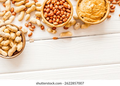 Desayuno vegano. Haga mantequilla de maní con nueces y pegue en un tazón sobre fondo de madera blanco