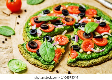 Vegan Broccoli Zucchini Pizza Crust With Spinach Pesto, Tomatoes, Onion And Olives. Toning. Selective Focus