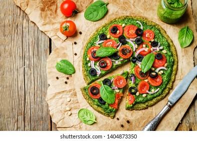 Vegan Broccoli Zucchini Pizza Crust With Spinach Pesto, Tomatoes, Onion And Olives. Toning. Selective Focus