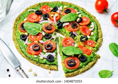 Vegan Broccoli Zucchini Pizza Crust With Spinach Pesto, Tomatoes, Onion And Olives. Toning. Selective Focus