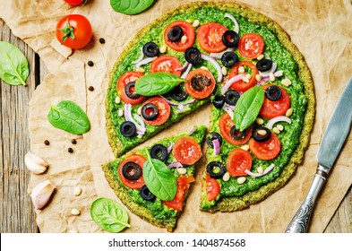 Vegan Broccoli Zucchini Pizza Crust With Spinach Pesto, Tomatoes, Onion And Olives. Toning. Selective Focus