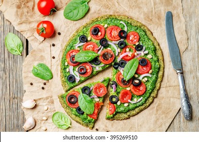 Vegan Broccoli Zucchini Pizza Crust With Spinach Pesto, Tomatoes, Onion And Olives. Toning. Selective Focus