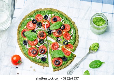 Vegan Broccoli Zucchini Pizza Crust With Spinach Pesto, Tomatoes, Onion And Olives. Toning. Selective Focus