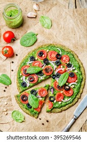 Vegan Broccoli Zucchini Pizza Crust With Spinach Pesto, Tomatoes, Onion And Olives. Toning. Selective Focus