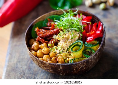 Vegan Buddha bowl with chickpeas, courgette, sundried tomatoes and sprouts