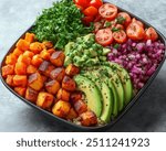 Vegan Buddha Bowl | A bowl filled with quinoa, roasted veggies, avocado slices, and a drizzle of tahini dressing.