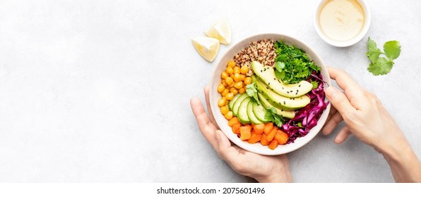 Vegan Buddha Bowl With Roasted Chickpeas And Tahini Sauce, Top Down View Of Hands Serving The Bowl, Huge Copy Space For A Text