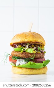 Vegan Burger With Avocado, Tomato And Peanut Sauce, White Background, Copy Space. Plant-based Diet Concept.