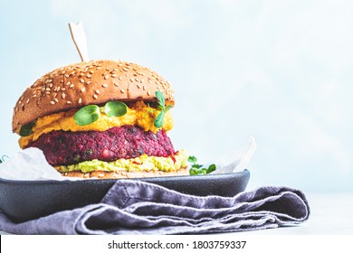 Vegan Burger With Beetroot Cutlet, Sweet Potato Sauce And Guacamole.