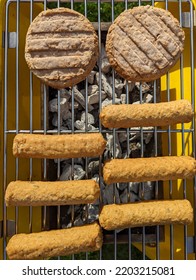 Vegan Burgers And Vegan Sausages Cooking On The Grill On A Coal Barbeque 