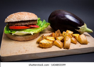 Vegan Burguer Made With Eggplant And Accompanied With Tomato, Lettuce, Avocado And Fries.