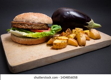 Vegan Burguer Made With Eggplant And Accompanied With Tomato, Lettuce, Avocado And Fries.