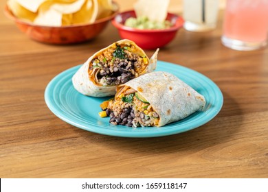 Vegan burrito made with rice, black beans, and various vegetables. Delicious Mexican food.
