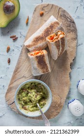 Vegan Burrito On Wooden Board With Guacamole.