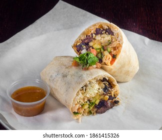 Vegan burrito with rice, bean, vegetables, and cashew cheese. Vegan Mexican food. 