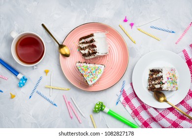 Vegan Carrot Cake Pieces With Cup Of Tea And Birthday Decorations And Supplies, Flatlay, Cement Background