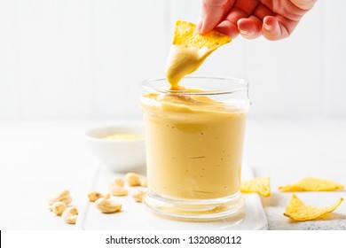 Vegan Cashew Cheese Sauce In A Glass, White Background. Plant Based Food Concept.