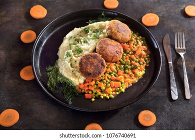 Vegan Cauliflower Cutlet Served With Potatoes And Carrots And Peas