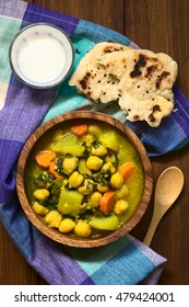 Vegan Chickpea Curry Or Chana Masala With Spinach, Potato And Carrot, Served With Naan Bread, Photographed Overhead With Natural Light