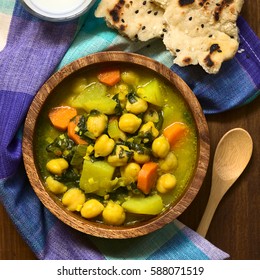 Vegan Chickpea Curry Or Chana Masala With Spinach, Potato And Carrot, Served With Naan Bread, Photographed Overhead With Natural Light